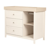 Wanderer changing table with drawers and removable top in cashmere, featuring an oak-effect top with guard rails, three drawers, and an open side shelf with hanging bar.