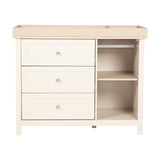 Wanderer Changing Table with three cashmere drawers, brushed metal knobs, oak-effect top with raised edges, and an open side section with shelf and hanging rail, on a plain white background.