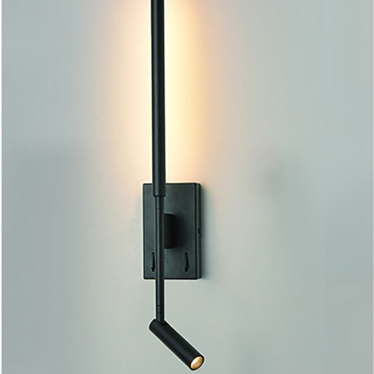 Luca Black LED Wall Light with slim upright bar, rectangular wall plate, and adjustable reading spotlight, mounted on a light grey wall with warm uplight glow.