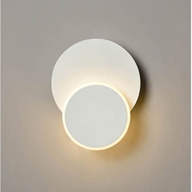 Crescent White Small LED Wall Light with two overlapping circular discs in matte white, the smaller disc glowing with warm light against a plain grey background.