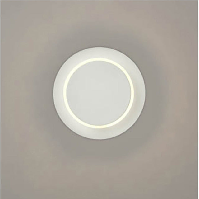 Crescent White LED Wall Light with a round matt white disc design and a soft glowing inner ring, mounted on a plain neutral wall.