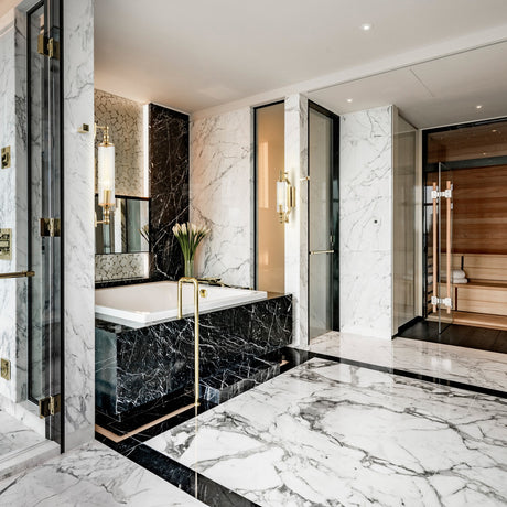 Empire wall light in gold finish, shown in a room setting