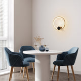 Eclipse wall light in black and gold finish, shown in a room setting
