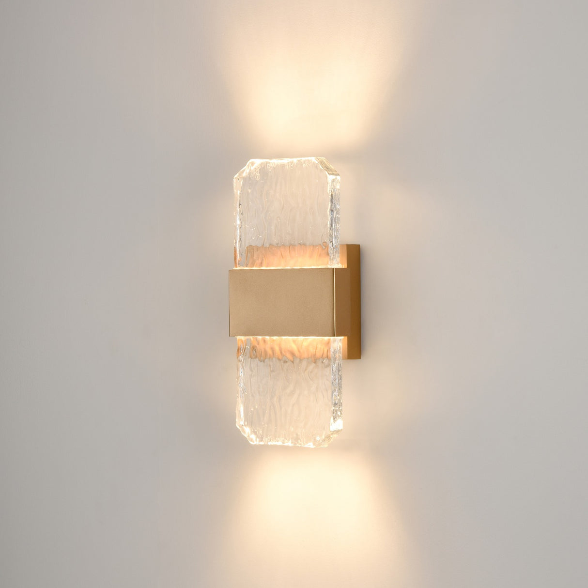 Frost exterior wall light in brass finish, shown on a dark background