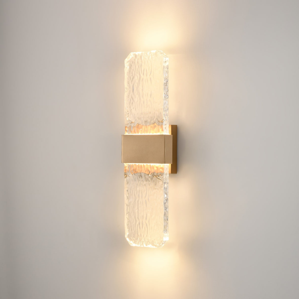 Frost exterior wall light in brass finish, shown on a dark background