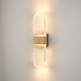 Frost exterior wall light in brass finish, shown on a dark background
