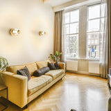 Beacon ceiling light in brass finish, shown in a room setting
