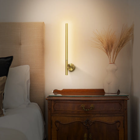 Fabula wall light in satin brass finish, shown in a room setting