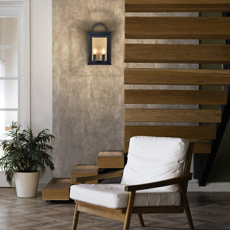 Nightingale 2 light exterior wall light in black and brass finish, shown in a garden setting