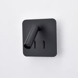 Luca Matt Black LED Wall Light with square backplate, adjustable cylindrical reading spotlight, and two vertical switches, shown against a plain white background.