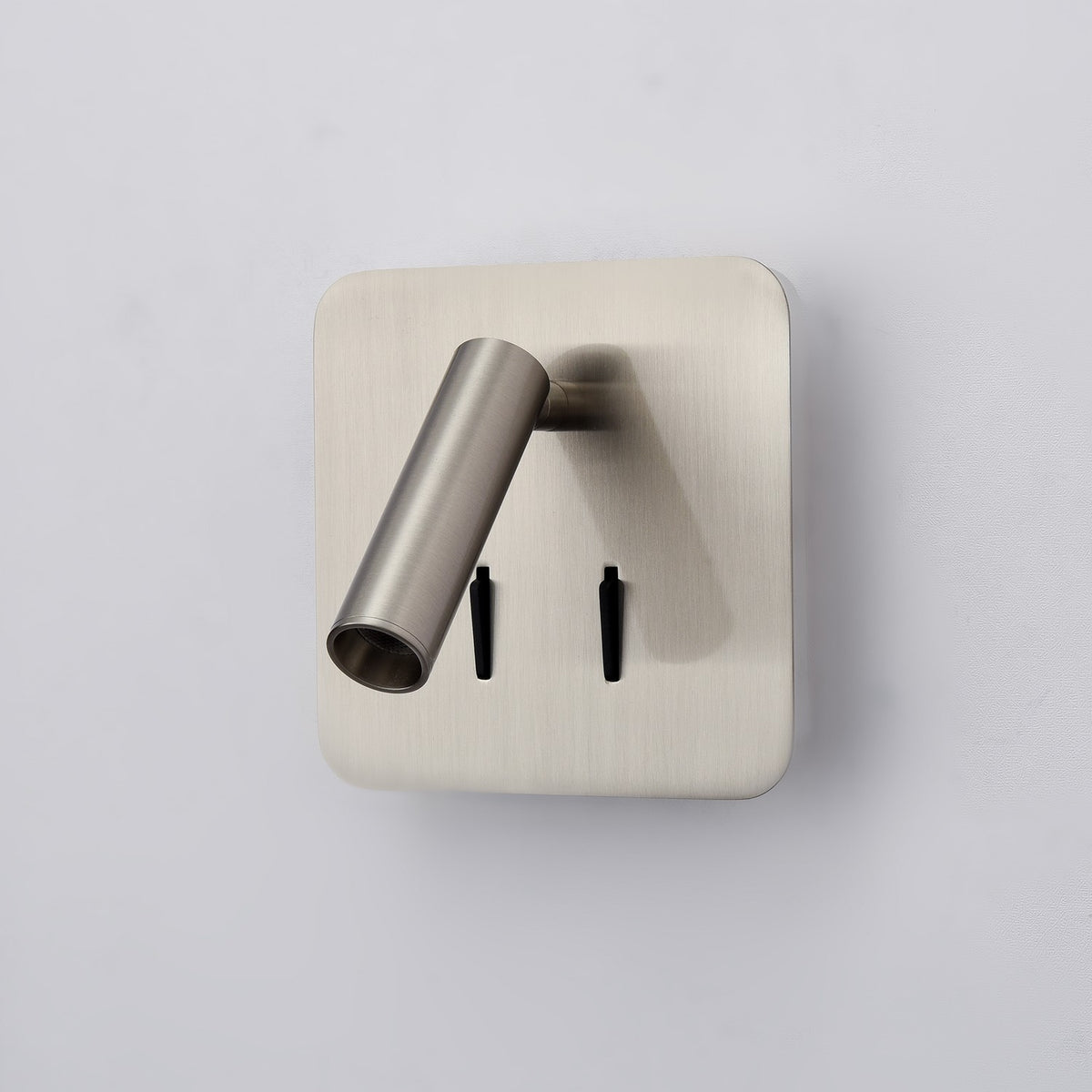Luca Satin Nickel Adjustable LED Reading Wall Light with cylindrical rotating head, square backplate, and two toggle switches, shown against a plain light background.