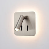 Luca Satin Nickel Adjustable LED Reading Wall Light featuring a square backplate, angled cylindrical spotlight head, two black rocker switches, and soft ambient backlight glow.