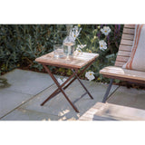 Yatin Outdoor Side Table - Natural in a garden
