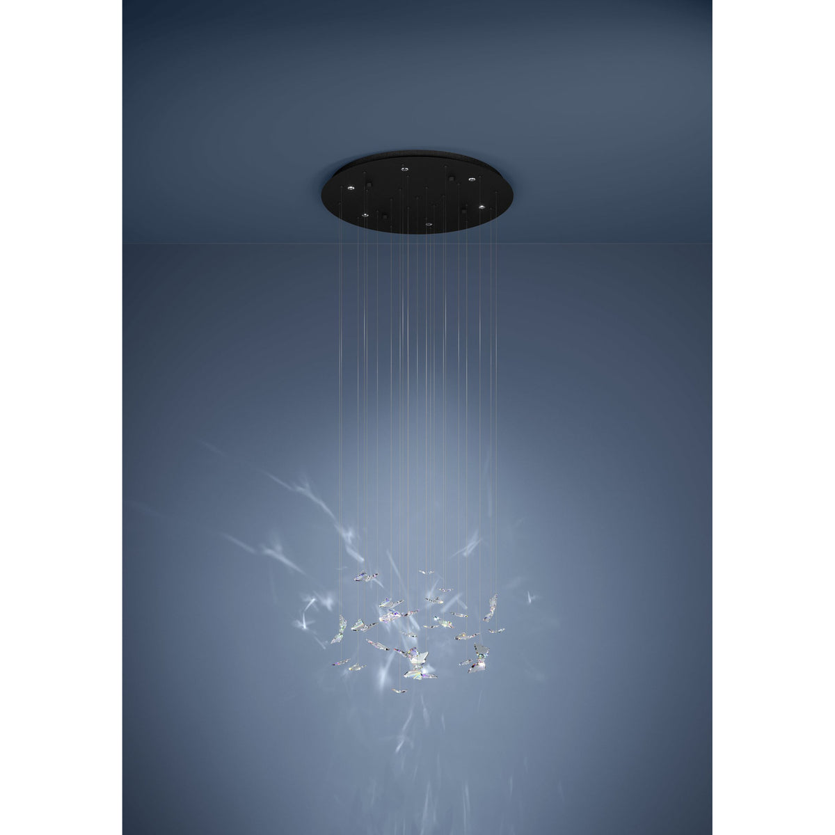 Adrados 6-light pendant with round black steel canopy and clear glass butterfly pieces suspended on fine wires, shown against a soft blue background.