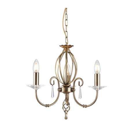 The Aegean 3 Light Chandelier - Aged Brass showcases timeless elegance with three candle-shaped bulbs perched on gracefully curved arms, finished in a classic aged brass. Its intricate central spiral design and hand-forged scrolls are beautifully accented by small glass ornaments, all suspended elegantly from a chain.