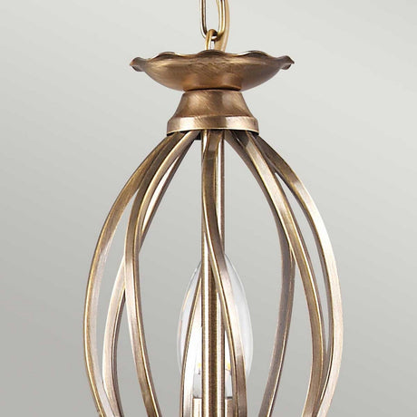 The Aegean 5 Light Chandelier - Aged Brass is a vintage-style chandelier featuring multiple bulbs encased in a cage-like metal frame with an aged brass finish, suspended from a chain.