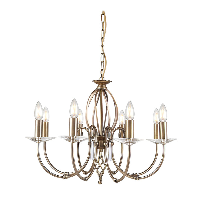 The Aegean 8 Light Chandelier in aged brass exudes vintage appeal with its antique gold finish. It features eight candle-shaped bulbs on elegant curved arms, and the central cage design gracefully hangs from a decorative chain.