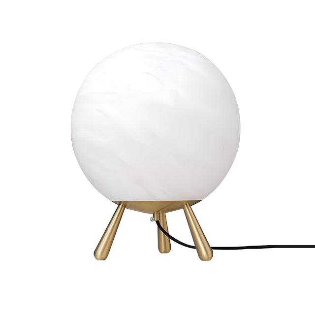 The Orlena Small Globe Alabaster Table Lamp in Brass & Soft White features a round white frosted glass shade resting on three angled brass legs, with a black power cord extending from the base.