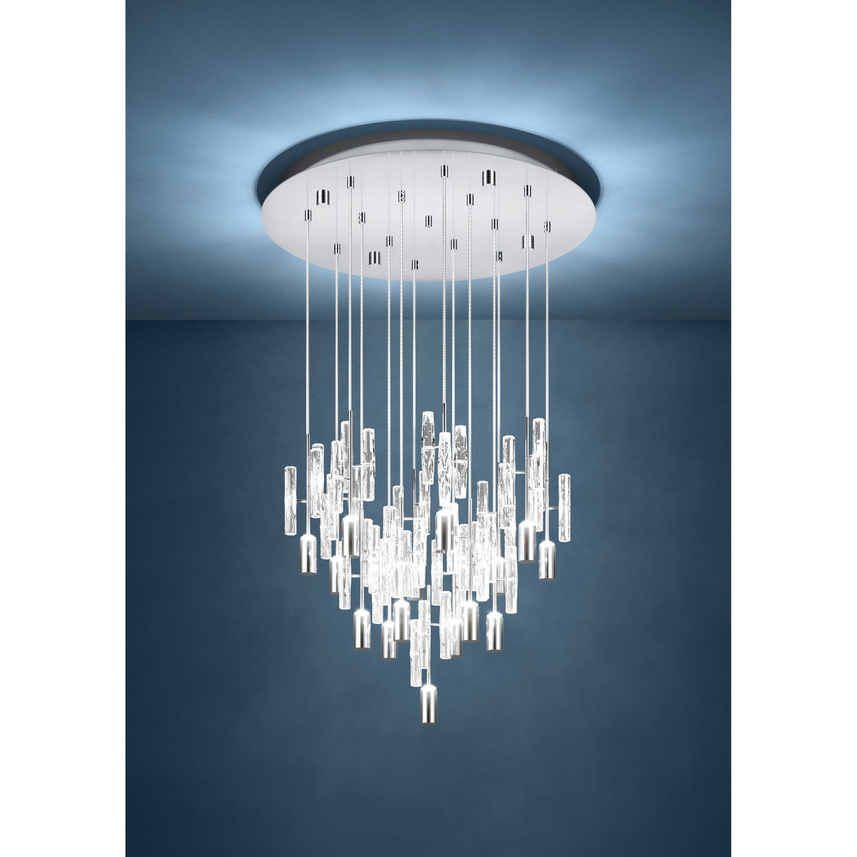 Alemdina 15 light pendant with clear glass rods and chrome cylinder caps cascading in staggered heights from a round chrome ceiling canopy, shown suspended in a dark blue-walled room.