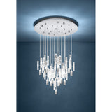 Alemdina 15 light pendant with clear glass rods and chrome cylinder caps cascading in staggered heights from a round chrome ceiling canopy, shown suspended in a dark blue-walled room.