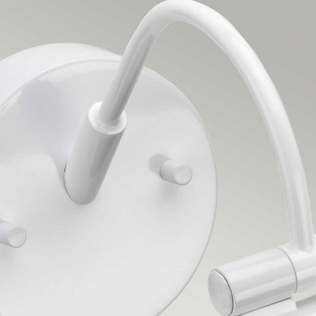 Close-up of the Alton 1 Light Large LED Picture Light in white, featuring a circular base and a curved cylindrical arm extending outward. It casts subtle illumination over the smooth, light grey background.