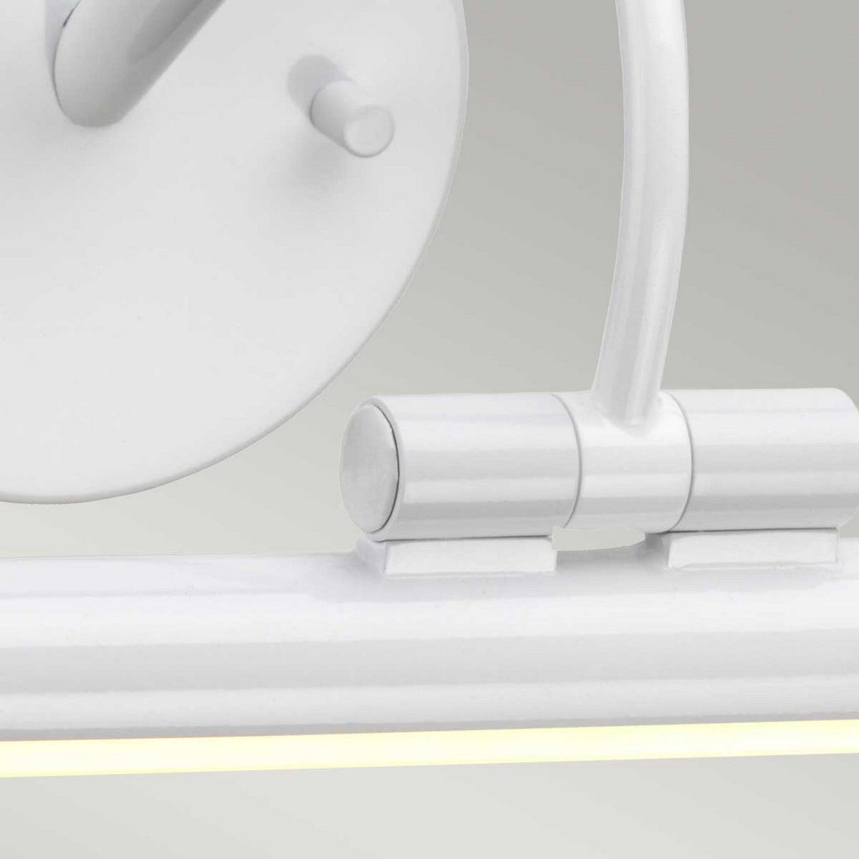 Close-up of the Alton 1 Light Large LED Picture Light in white, showcasing a sleek, modern design with a cylindrical fixture and adjustable arm. This energy-efficient LED provides a subtle glow that enhances its minimalist style. Perfect for art lighting, it elegantly illuminates against a plain backdrop.