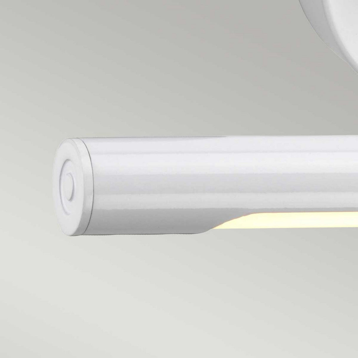 The Alton 1 Light Small LED Picture Light in white, mounted on a light gray wall, features a clean and modern design. This energy-efficient fixture emits a soft glow from below, enriching spaces with its subtle illumination.