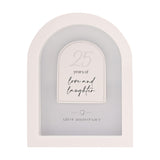 White MDF arched wall plaque with raised panel reading "25 years of love and laughter" and "silver anniversary" beneath a small heart, on a plain background.