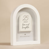 White arched MDF plaque, 18cm, with a raised arch panel reading "25 years of love and laughter" and "silver anniversary" beneath a small heart detail, on a plain background.