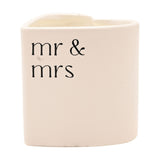 Heart-shaped scented candle in a white ceramic holder printed with "mr & mrs" in black lowercase lettering, shown against a plain white background.