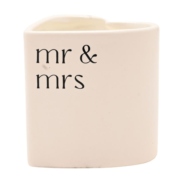 Heart-shaped scented candle in a white ceramic holder printed with "mr & mrs" in black lowercase lettering, shown against a plain white background.
