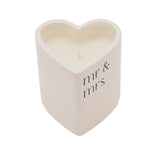 Heart-shaped white ceramic candle holder printed with "mr & mrs" in black lowercase lettering, filled with creamy wax, shown on a plain white background.