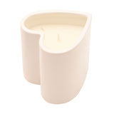 Heart-shaped scented candle in a white ceramic holder with rounded sides, filled with creamy wax and twin wicks, shown on a plain white background.