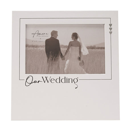 White wooden freestanding photo frame for a 6 x 4in wedding picture, with "Our Wedding" text and three silver hearts in the corner on a square white panel.