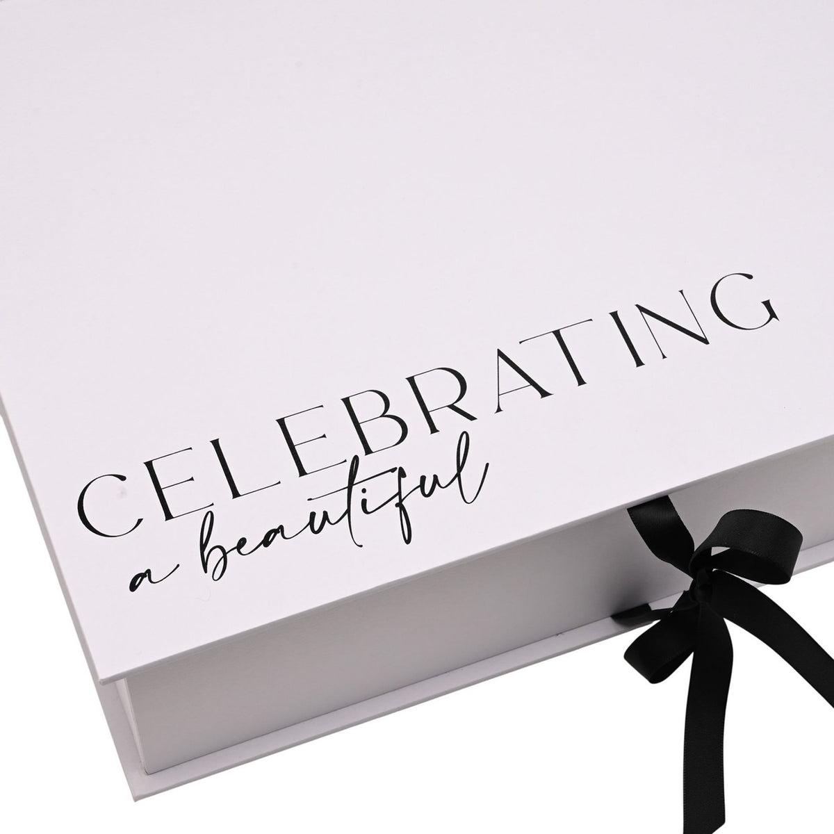 White rectangular A4 keepsake box with hinged lid printed "Celebrating a beautiful bride to be" in black script, closed with a black ribbon tie.