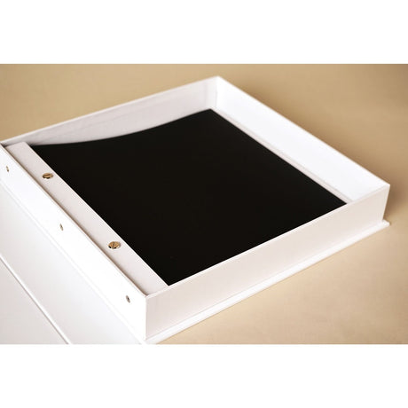 The Story of Us Square Coffee Table Photo Album in white with screw-bound black pages visible, open on a neutral surface.
