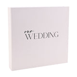 Square white "Our Wedding" photo album with matching box, featuring "our" in script and "WEDDING" in capitals on the front, shown against a plain background.