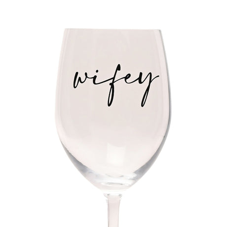Clear tulip-shaped wine glass, 23.4cm, with "wifey" in black script lettering across the bowl, long slender stem, on a plain white background.