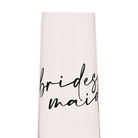 Close-up of a clear glass champagne flute with "bridesmaid" written in black script across the bowl, shown against a plain white background.