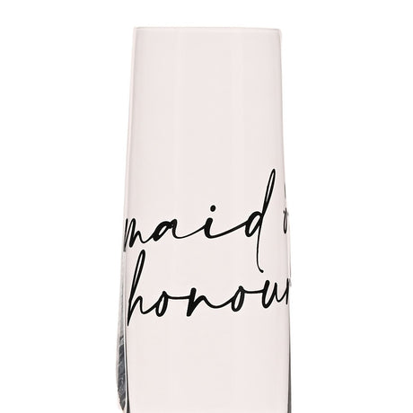 Close-up of a clear glass champagne flute with "maid of honour" in black handwritten script across the bowl, set against a plain white background.