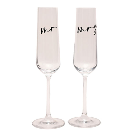 Set of 2 clear champagne flutes with "mr" and "mrs" in black script on the upper bowl, tall narrow bowls on slender stems, shown on a plain white background.
