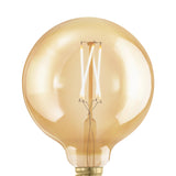 Amber glass LED globe bulb (G125, E27) with visible zigzag filaments on a clear stem and brass-coloured cap, shown close-up against a plain white background.