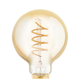 Amber glass LED globe bulb, G80 round shape, with spiral filament coiled around a central stem and gold-toned E27 screw cap, shown close-up on a white background.