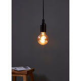 Amber Dimmable LED Globe Bulb E27 G80, lit with visible spiral filament, fitted to a black pendant light fixture against a dark grey wall.
