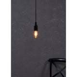 Amber LED bulb E27 with tapered glass body and visible filaments, lit warm white in a pendant fitting against a dark textured wall.