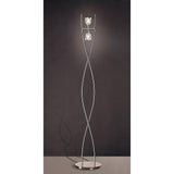 The Amel 2 Light Floor Lamp in polished chrome features a modern, twisting metal frame and two glass fixtures on a round base, shown against a dark background.