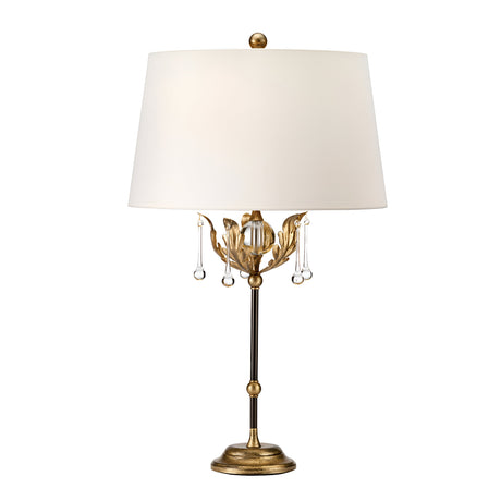Introducing the Amarilli 1 Light Table Lamp, a captivating piece from our Handmade range. It boasts a bronze base with intricate detailing and delightful hanging crystal accents. The exquisite gold patina finish exudes warmth, complemented perfectly by an ivory lampshade for soft ambient illumination. Standing gracefully on a round pedestal, this lamp masterfully combines classic elements in its design.