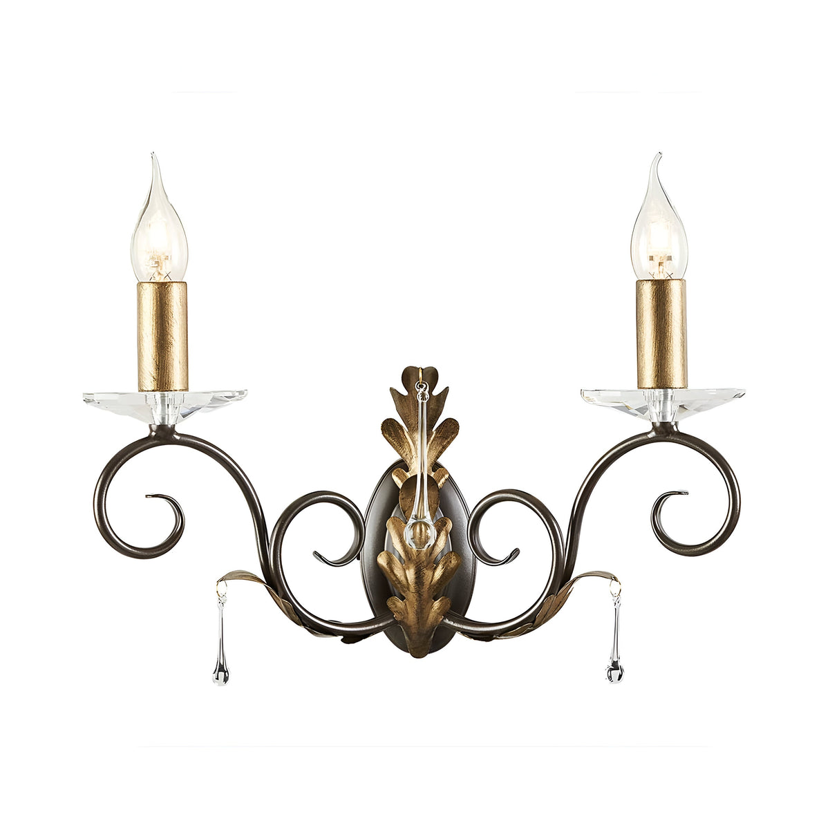 The Amarilli 2 Light Wall Light – Bronze With Gold Patina exudes the charm of an Elstead chandelier, featuring two candle-like bulbs and a luxurious design. Its ornate bronze with gold patina finish is complemented by delicate scrollwork adorned with crystal droplet details, all beautifully mounted on an oval backplate.