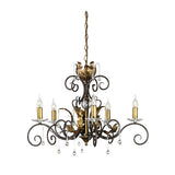 The Amarilli 5 Light Chandelier - Bronze With Gold Patina by Elstead Lighting showcases five candle-shaped lights, intricate black iron scrollwork, and elegant gold leaf accents. The vintage-style chandelier is embellished with hanging crystal drops, offering a sophisticated and timeless appearance.