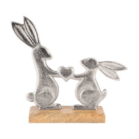 Amoatsy Rabbit Ornament 21cm in textured silver aluminium, two rabbits holding a heart between them, mounted on a natural mango wood base against a plain white background.